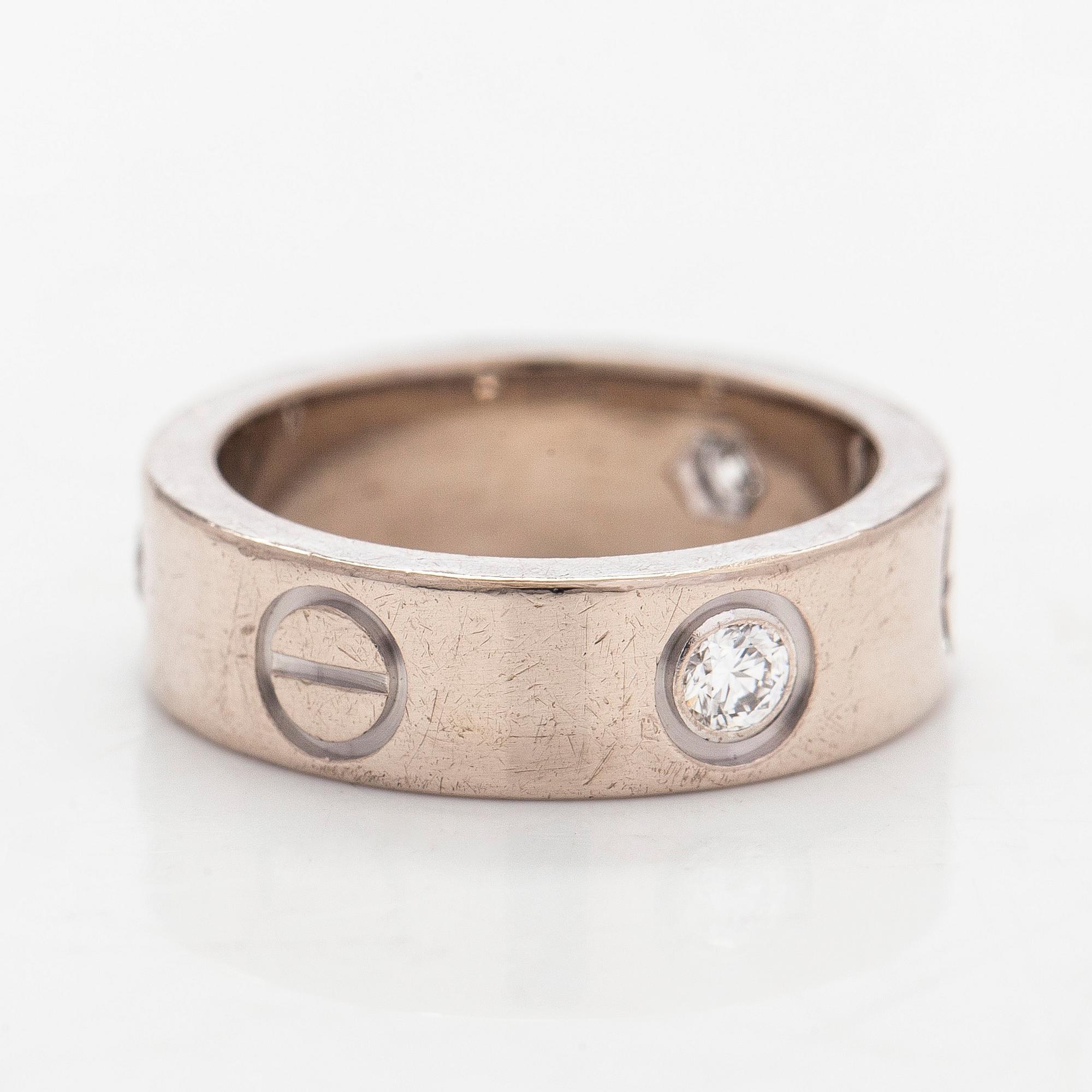 Cartier, an 18K white gold 'Love' ring with three brilliant-cut diamonds.