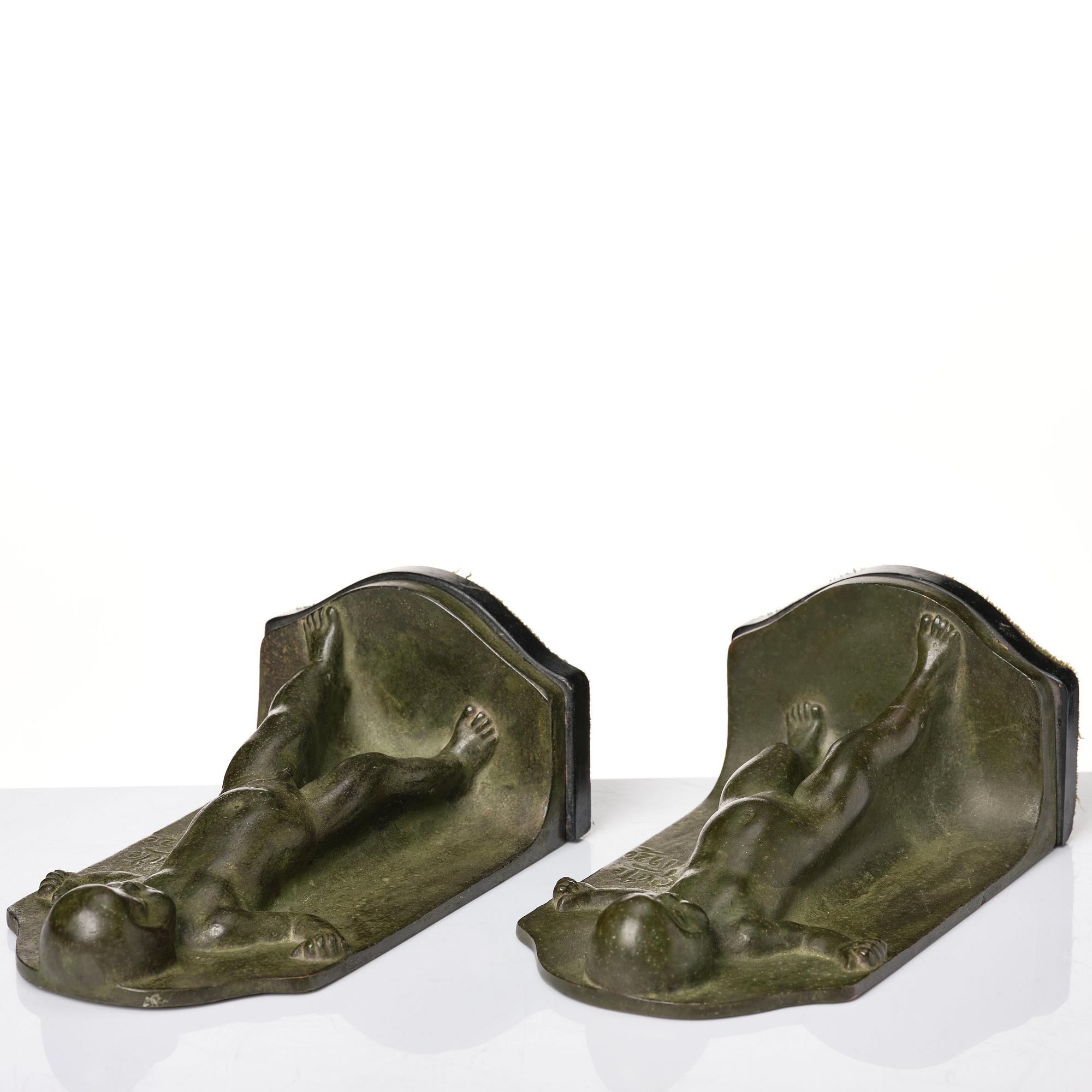Axel Gute, a pair of green patinated metal bookends, Sweden, dated 1920.