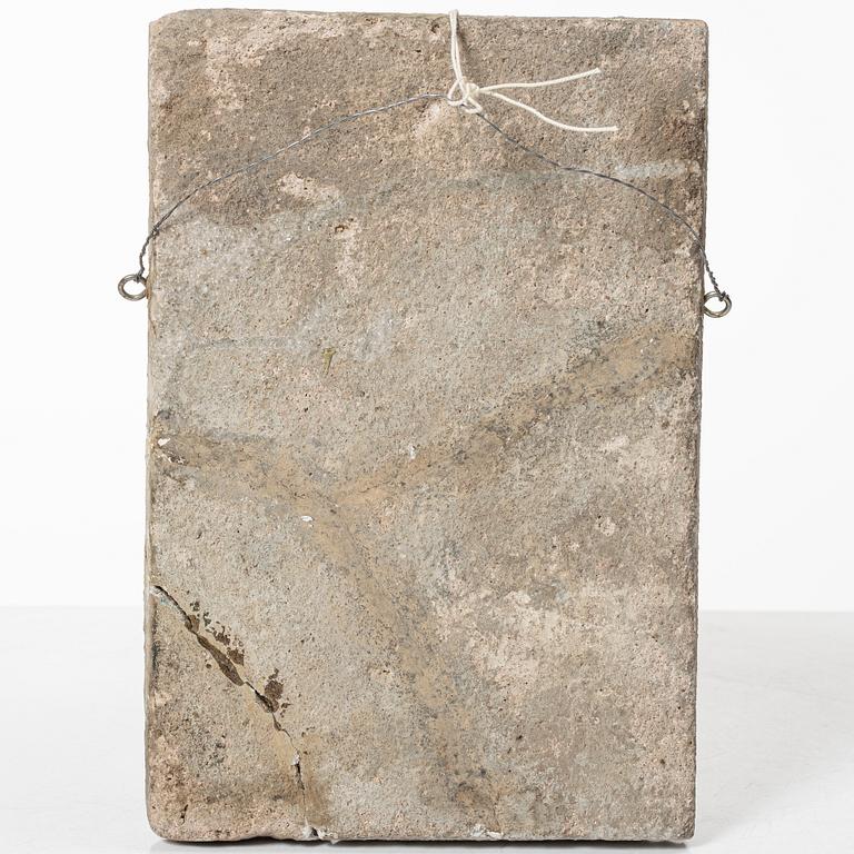 A Qajar moulded figural pottery tile, ca 26 x 19 cm.