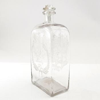 Brännvinsflaska, glas. Daterad Broby 1856.