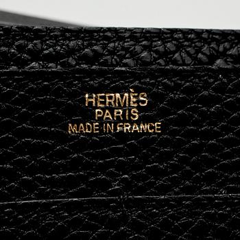 HERMÈS, a black leather wallet, "Dogon".