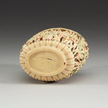 A deeply carved ivory snuff bottle with cover, China, early 20th Century.
