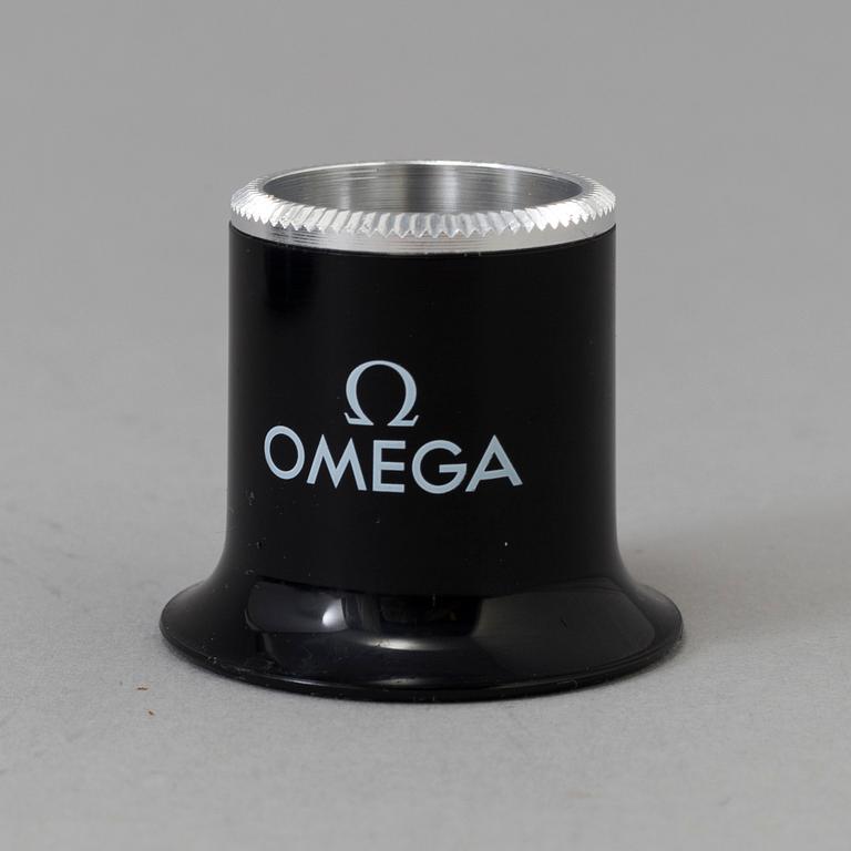 OMEGA, Pen / Loupe / Velcro strap.
