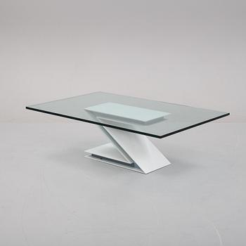 A grey lacquered metal and glass sofa table.