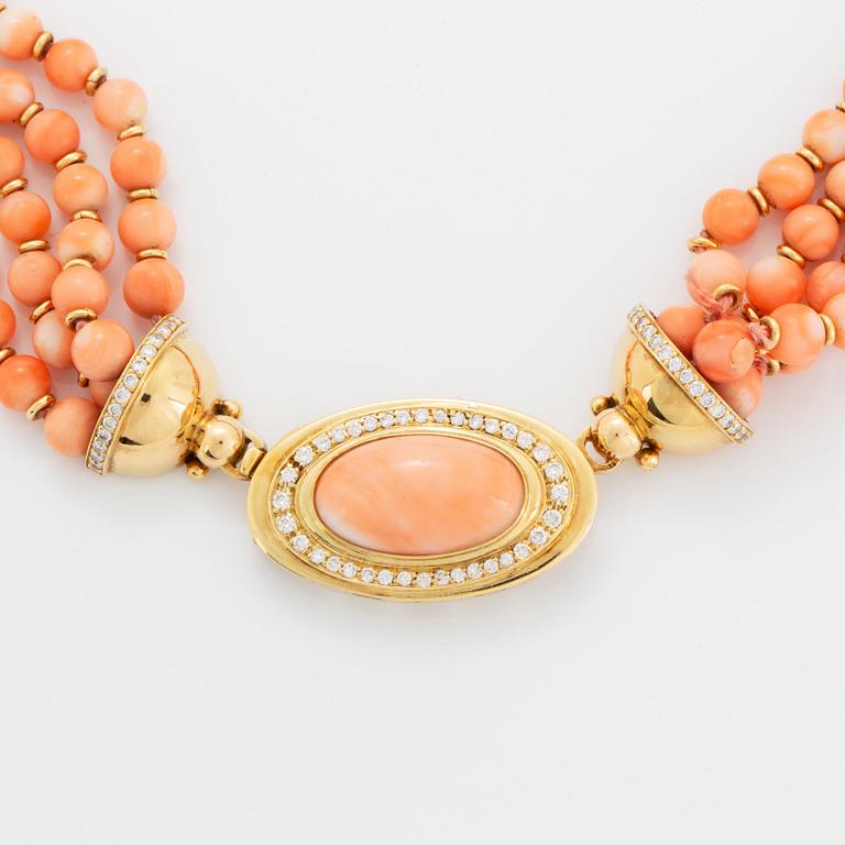 A four strand coral necklace with an 18K gold clasp set with coral and round brilliant-cut diamonds.