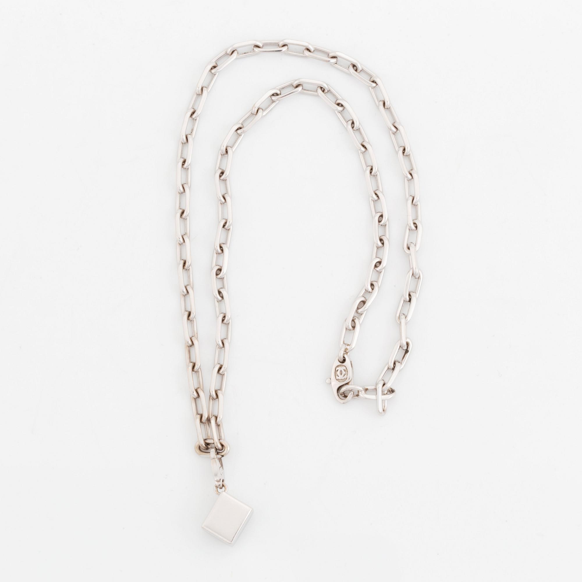 An 18K gold and white gold Cartier necklace with a charm.