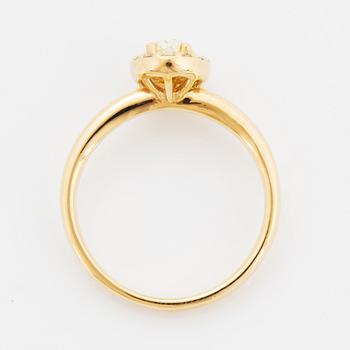 Oval light yellow diamond and brilliant-cut diamond ring.