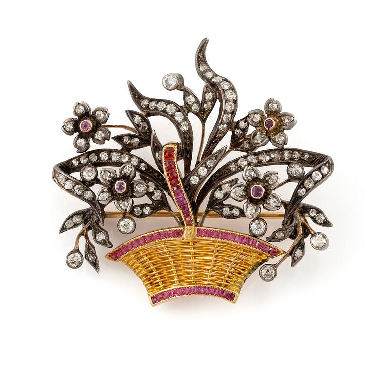 A brooch in 18K gold with diamonds and rubies in the form of a flower basket.