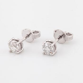 A pair of brilliant cut diamond earrings.