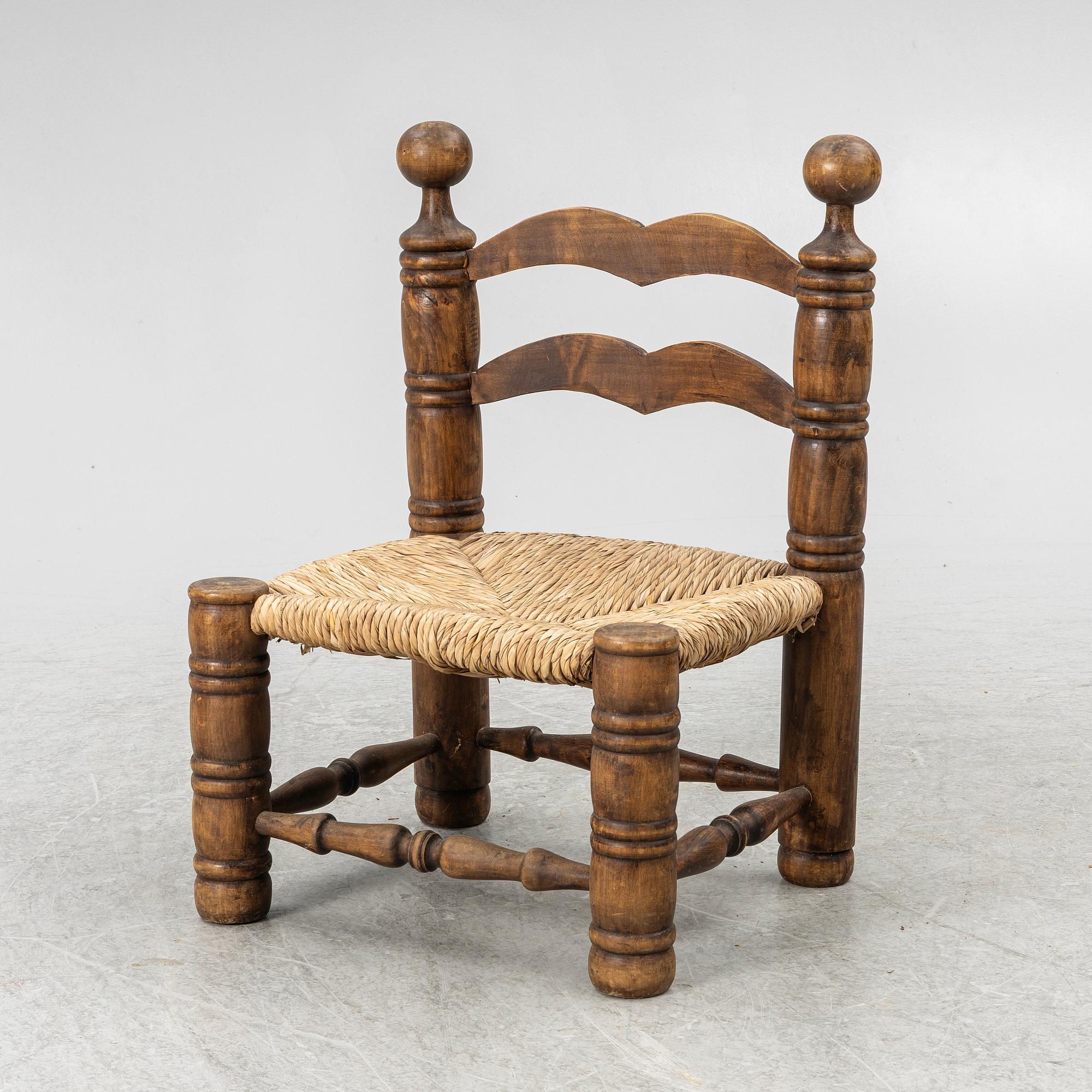 Charles Dudouyt, attributed to, a fireside low chair, mid 20th century.