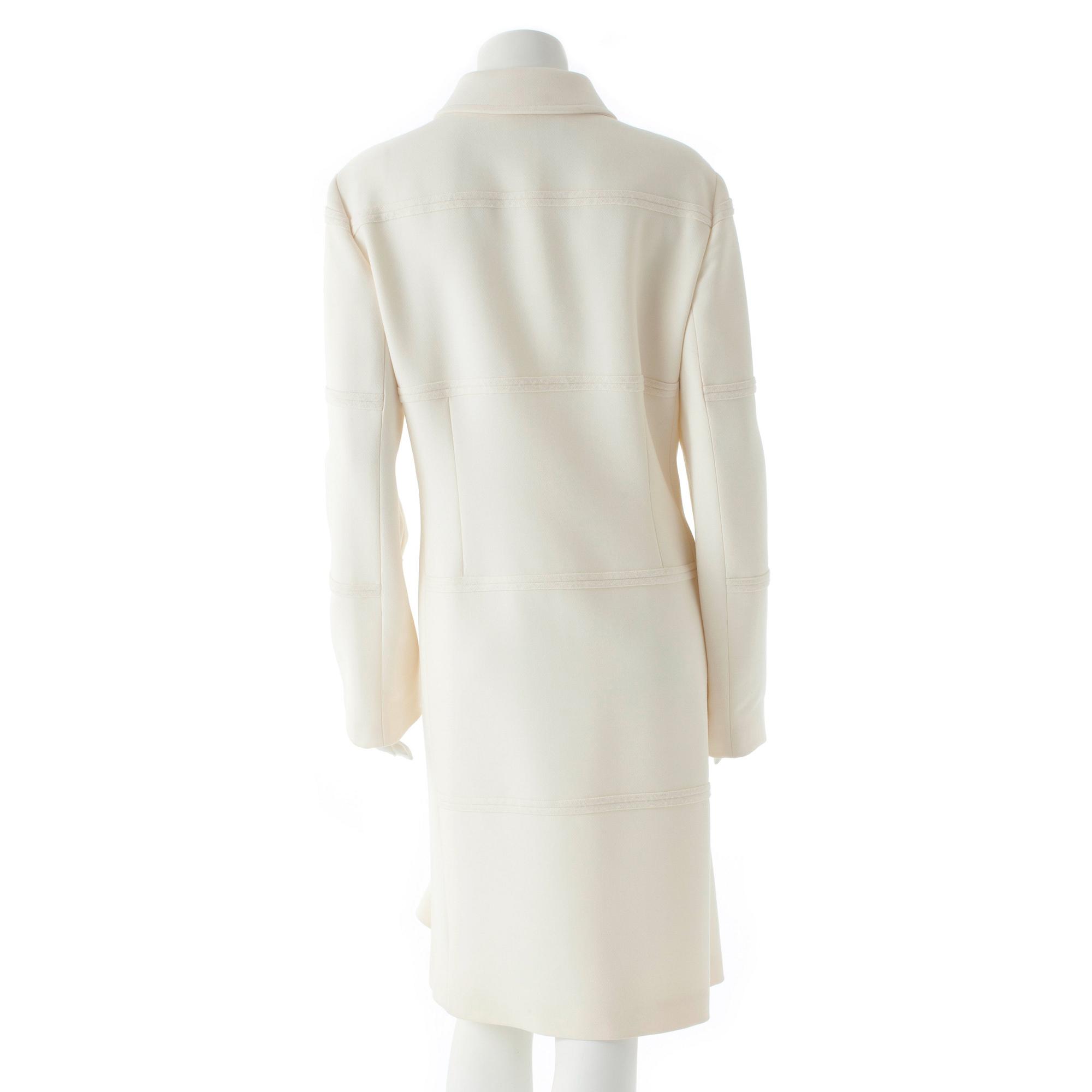 CARACTÈRE, a white wool coat.