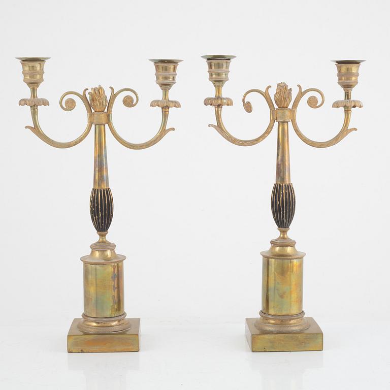 A pair of Swedish Empire two-branch gilt-brass candelabra, 1820's/30's.