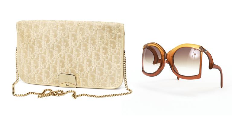 A clutch and sunglasses by Christian Dior.
