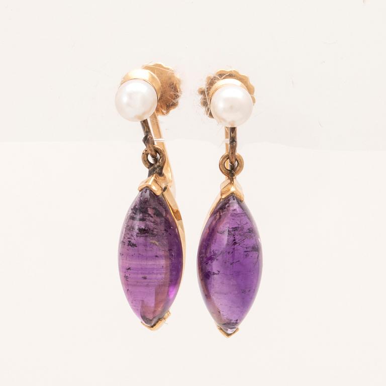 A pair of 18K gold earrings set with cabochon-cut amethysts and seed pearls, Stockholm 1961.