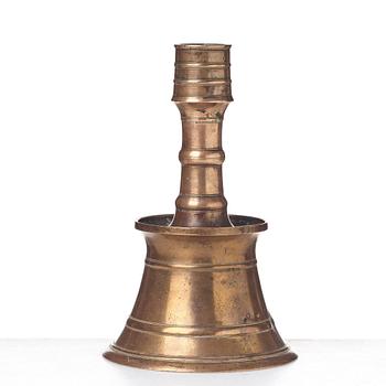 A CANDLESTICK, bronze/copper alloy, Ottoman, Turkey 16th-17th century, height 24 cm, the foot diameter 15,5 cm.