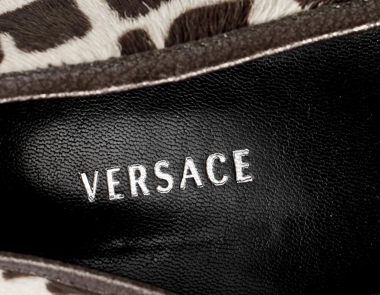 A pair of lady shoes by Versace.