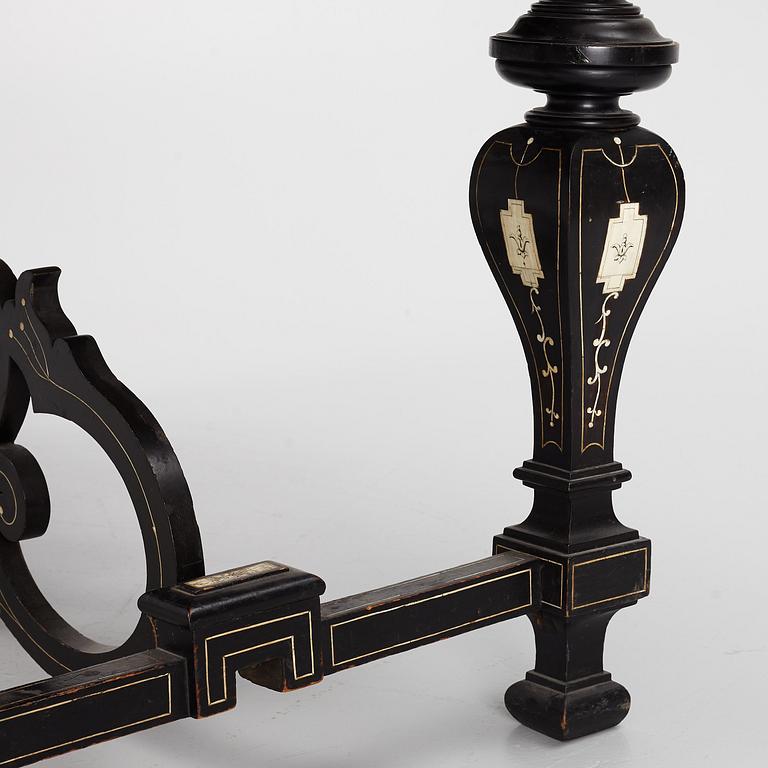 A Renaissance-style ebony, ebonized and ivory-inlaid library table, late 19th century, presumably Germany.