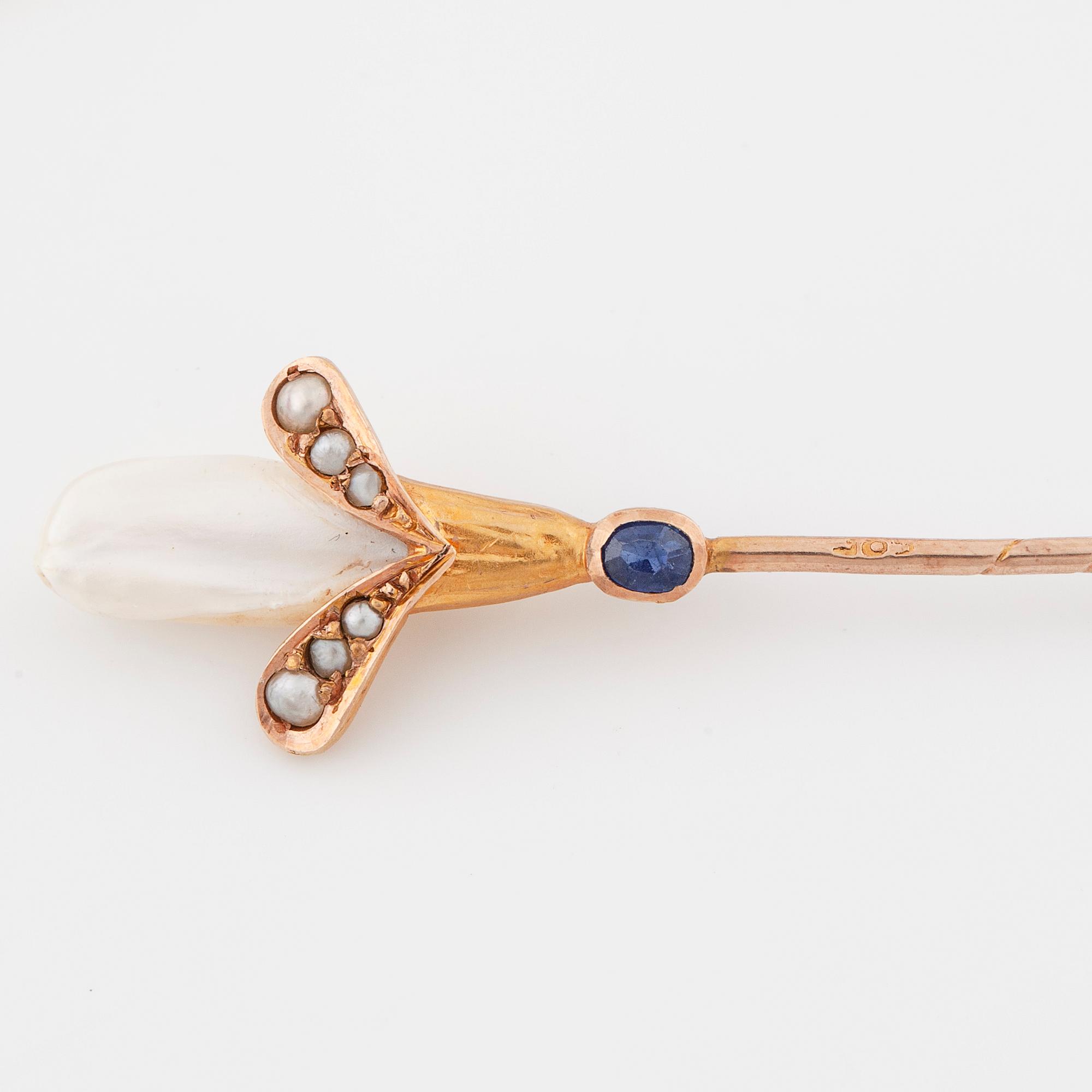 Two pins set with cultured pearls and a synthetic ruby and a synthetic sapphire.