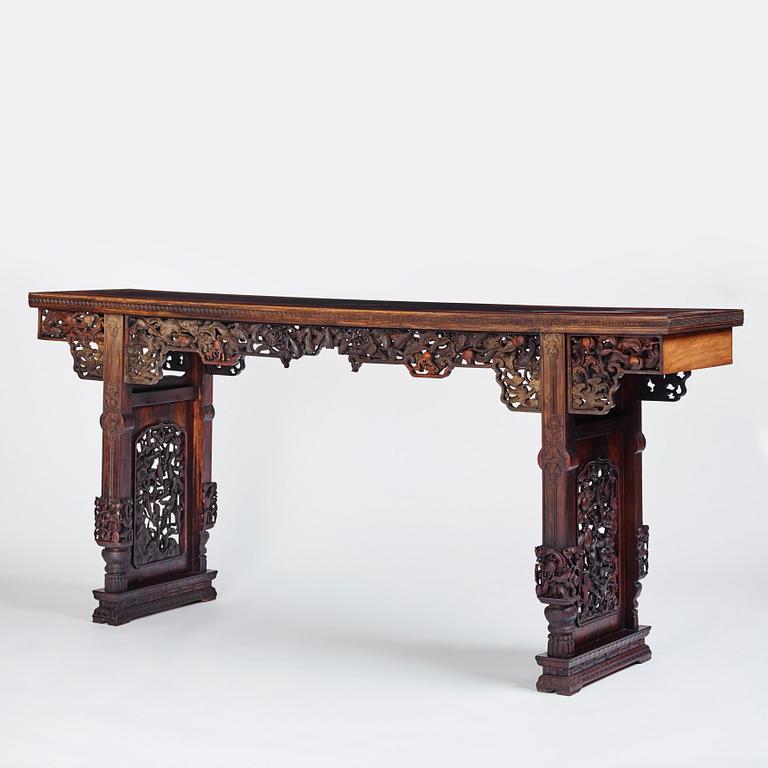 A massive zitan recessed-leg long table 'Jiaotousun Qiotouan', Qing dynasty, 19th century.