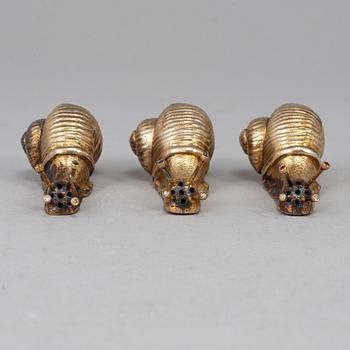 A set of three silver gilt salt-cellars, unmarked.