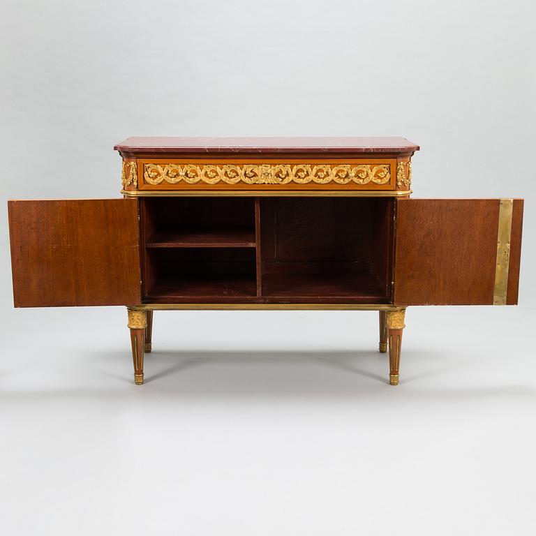 A French chest of drawer in Louis XVI style after Jean-Francois Leleu's school, late 19th century.