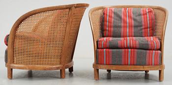 A pair of Oscar Nilsson beech and rattan arm chairs.