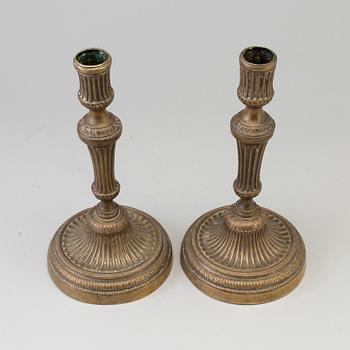 A pair of late 18th century bronze candlesticks.