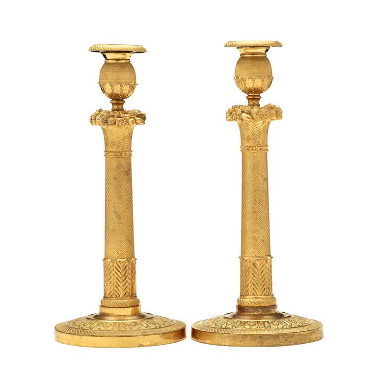 A pair of Empire early 19th century candlesticks. Signed GF.