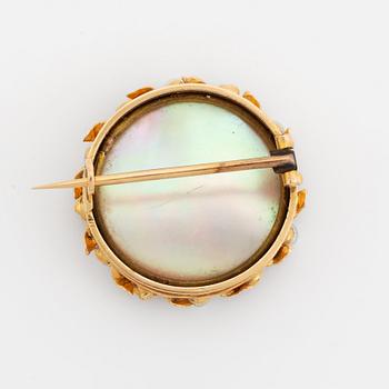 Brooch with miniature portrait on mother of pearl.