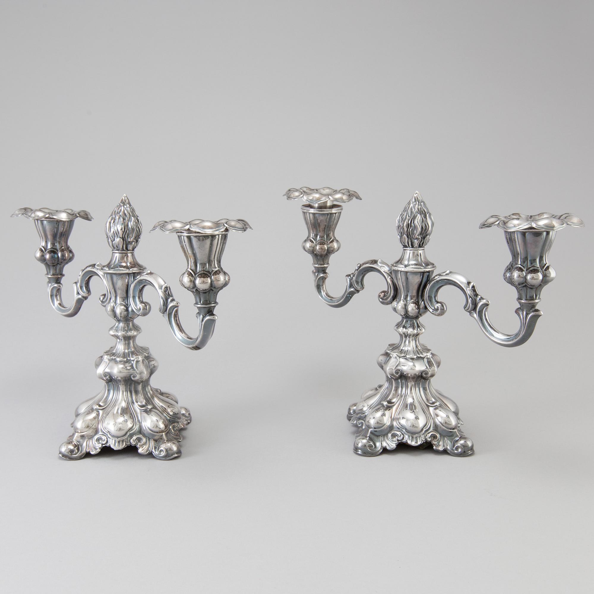 A pair of Swedish Rococo style silver candelabras from C G Hallberg in Stockholm 1955 and 1959.