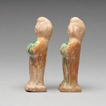 Two green and yellow glazed pottery figures of female attendants, Ming dynasty (1368-1644).