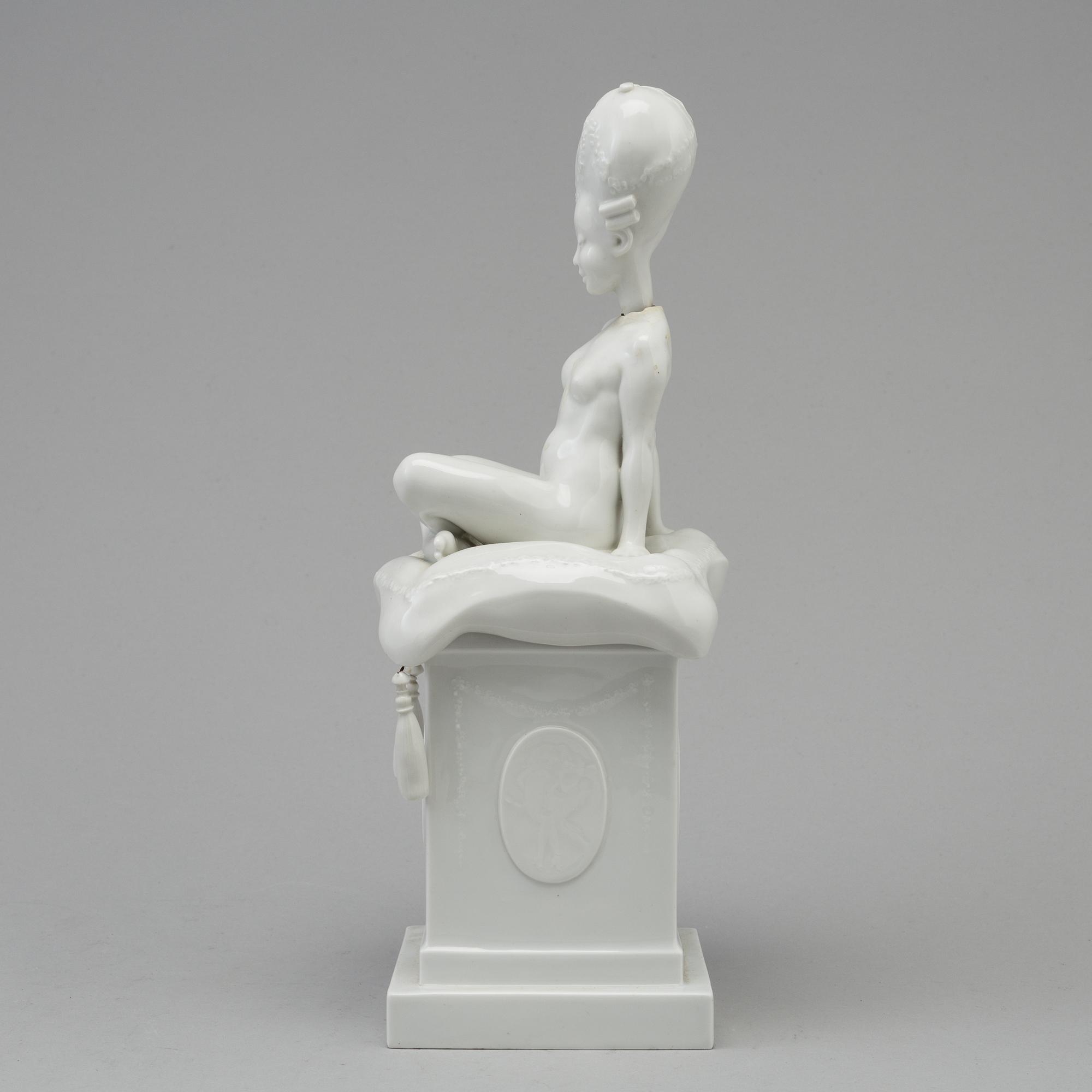 A white glazed Royal Copenhagen porcelain nodding head figure, Denmark, early 20th Century. Not first quality.