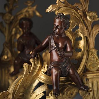 A pair of Louis XV-style 19th century fire dogs.