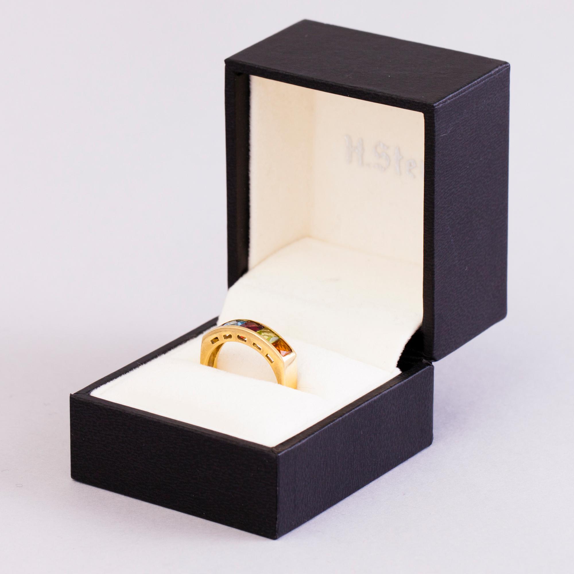 A 18K gold ring with 5 different stones: citrine, amethyst, topaz, garnet, peridot and a small diamond. Probably H.Stern.