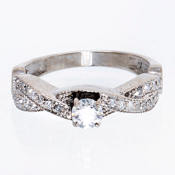 Ring 18K vitguld med 1 briljant ca 0,30 ct och briljanter ca 0,15 ct totalt.