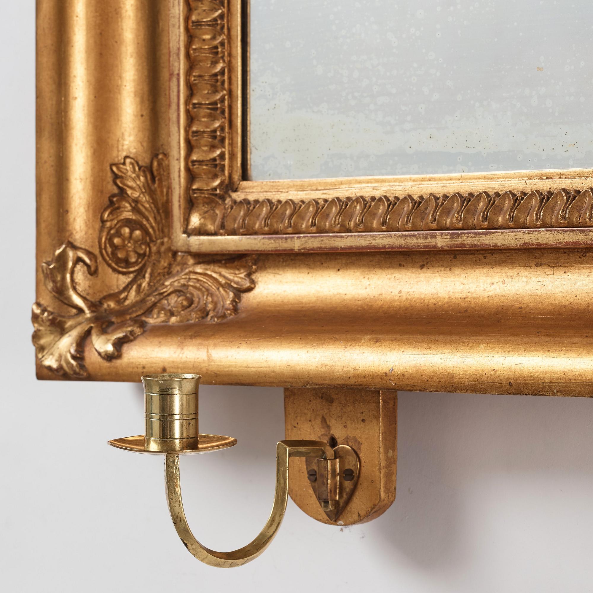 A pair of Swedish Empire two-light girandole mirrors, first half of the 19th century.