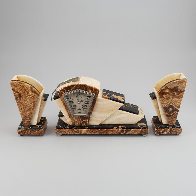 A three piece clock garniture, Art Deco style, 20th Century.