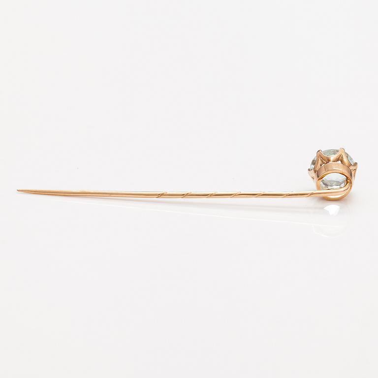 A 14K gold tiepin with a aquamarine.