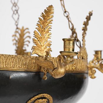 A presumably Russian Empire gilt and patinated bronze nine-branch chandelier, 19th century.