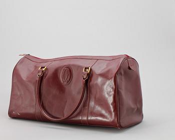 1452. A bordeaux coloured leather weekendbag by Cartier.