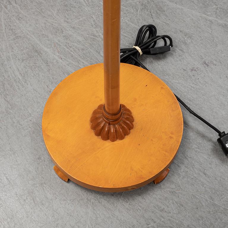 A 1940s birch wood floor lamp.