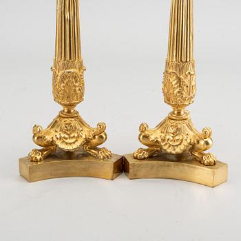 A pare of late empire candelsticks mid 19th century.