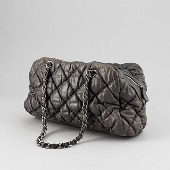 Chanel, a grey leather bag.