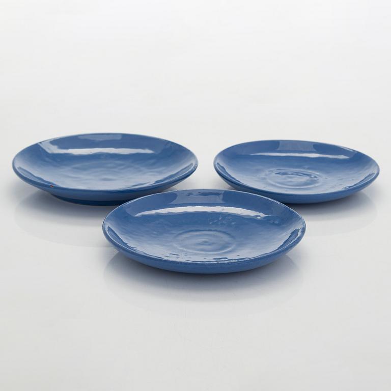 Marita Lybeck, a set of three ceramic plates and cream jug, red clay, signed ML.