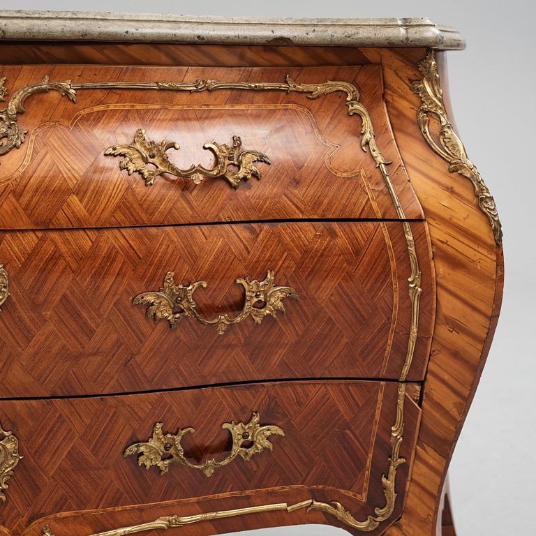 A rococo rosewood-veneered and ormolu-mounted commode by N. Korp (master 1763-1800).