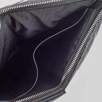 Bottega Veneta, a black leather handbag.