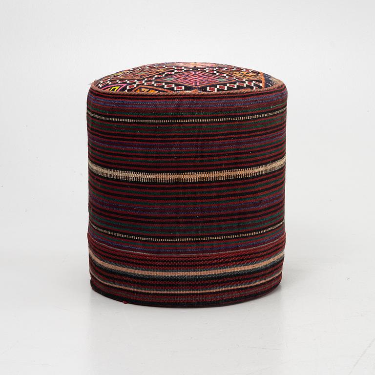 A Kelim covered stool.