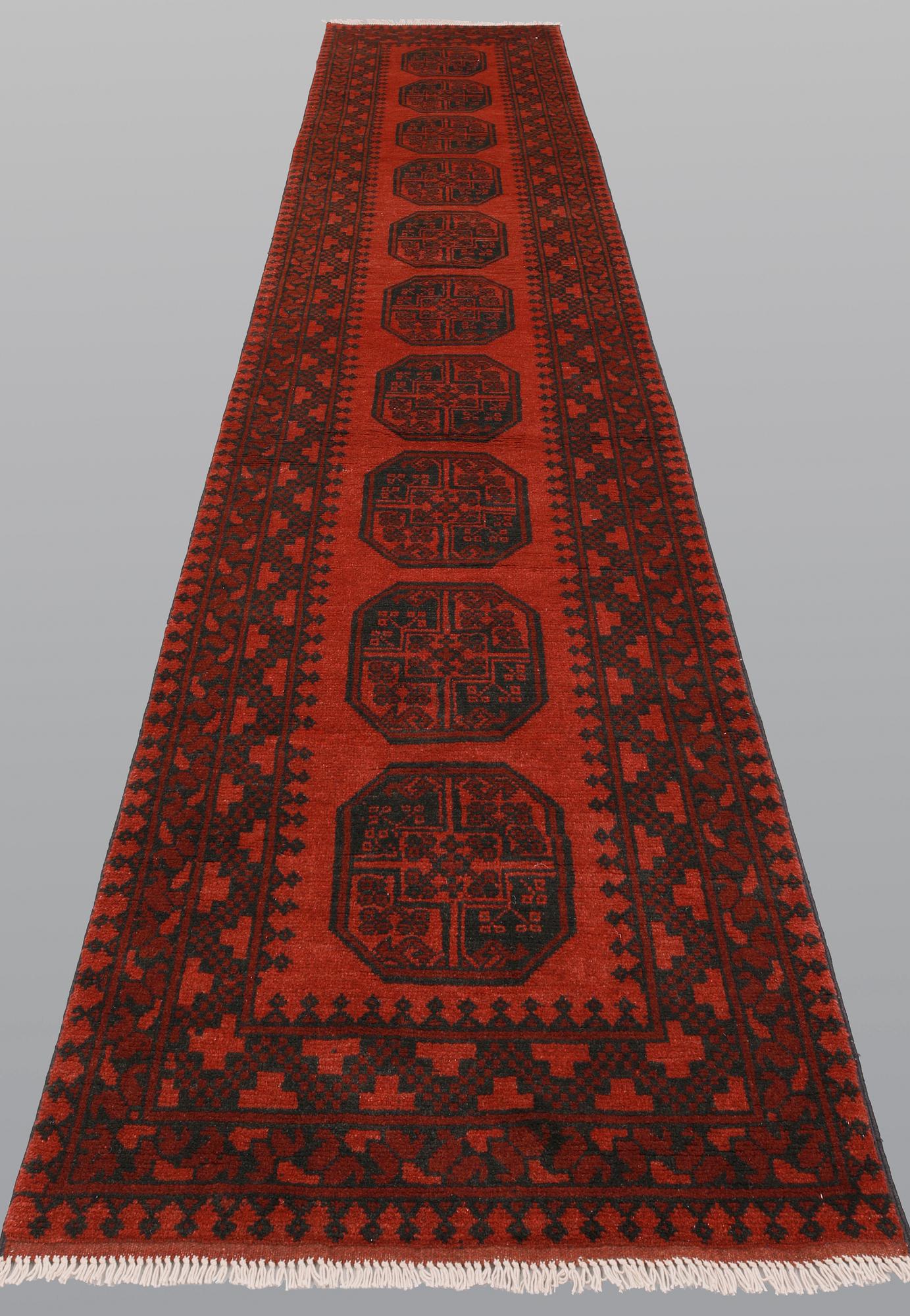 An Afghan runner, ca 383 x 78 cm.