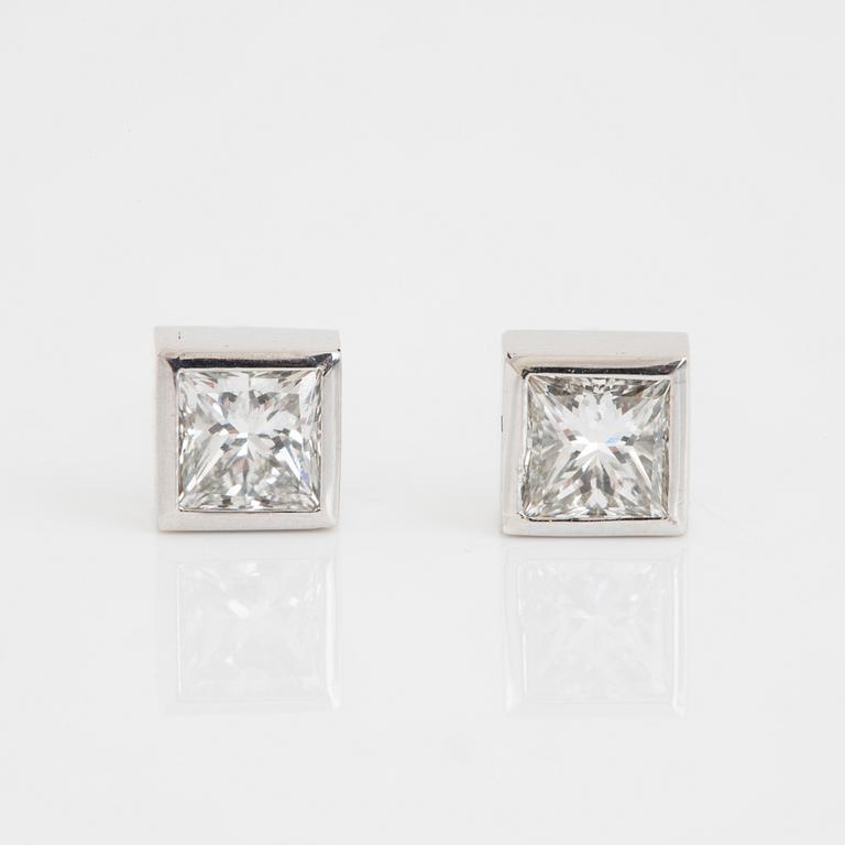 A pair of square modified brilliant cut diamond earrings.