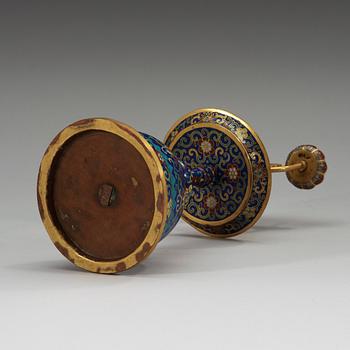 A fine Cloisonné candlestick holder with floral scrolls against a deep blue back ground, Qing dynasty, 18th Century.